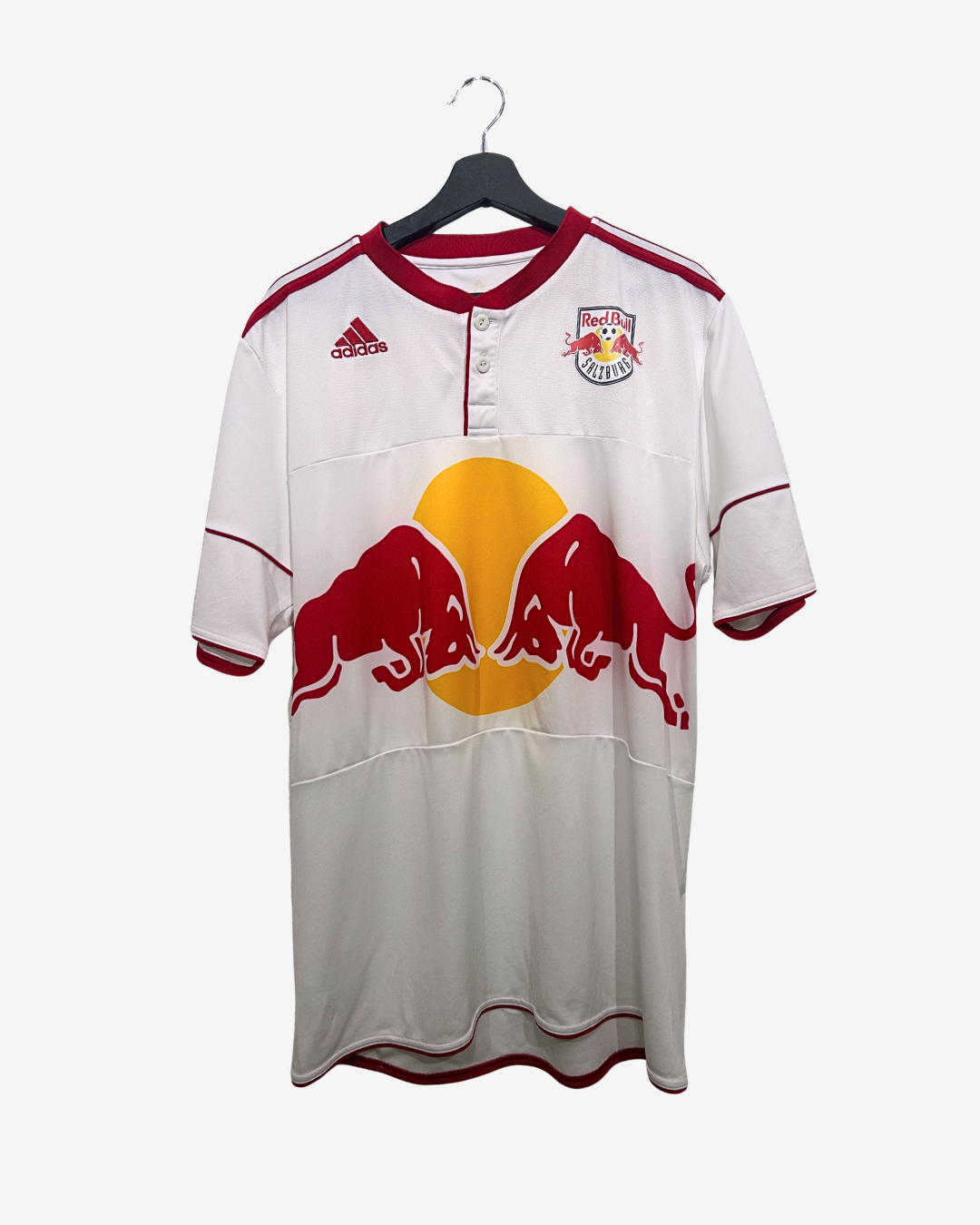 White sports jersey with red and yellow logos on a hanger against a white background