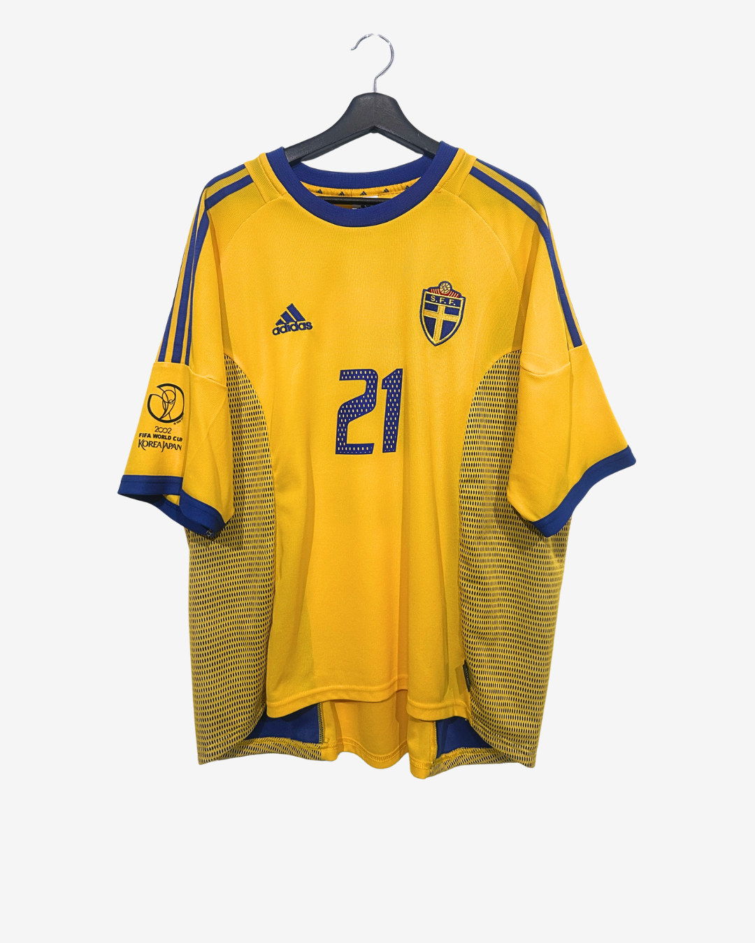 Yellow soccer jersey with blue accents and number 21 on a hanger against a white background