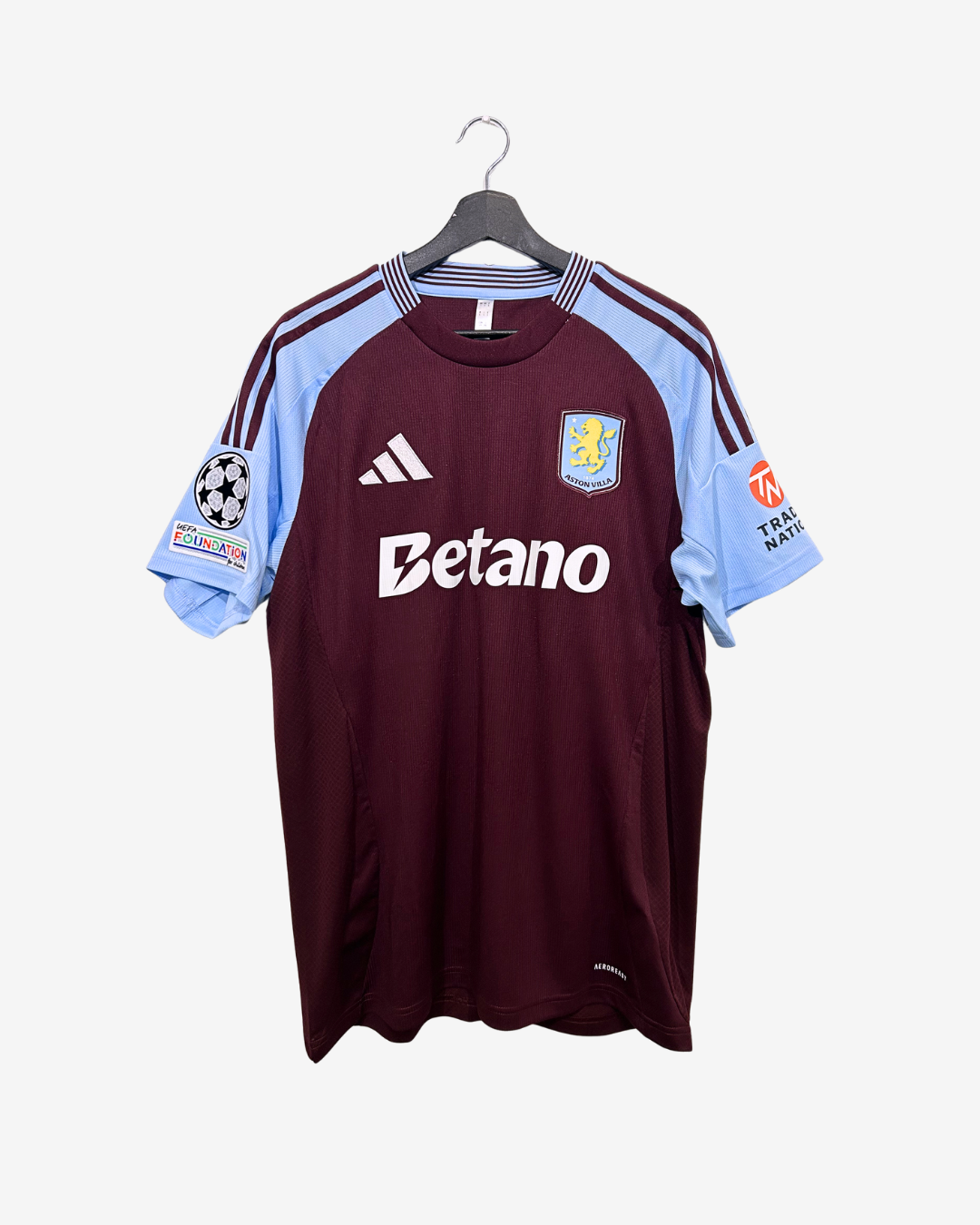 Maroon sports jersey with light blue sleeves on a hanger against a white background
