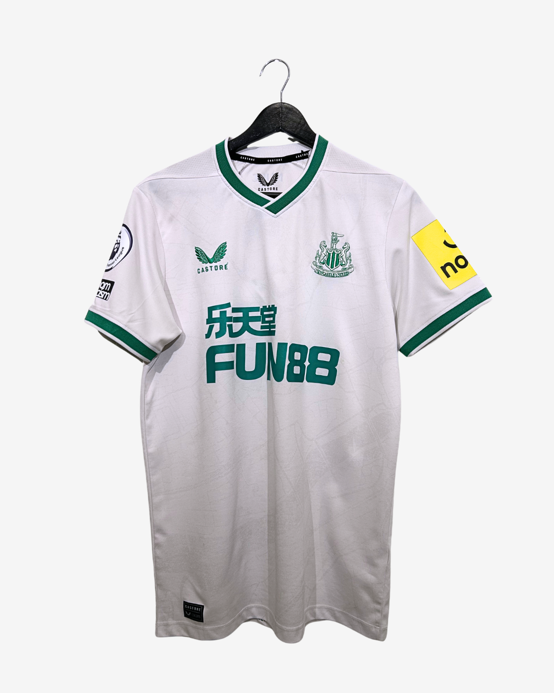 White sports jersey with green accents on a hanger against a white background