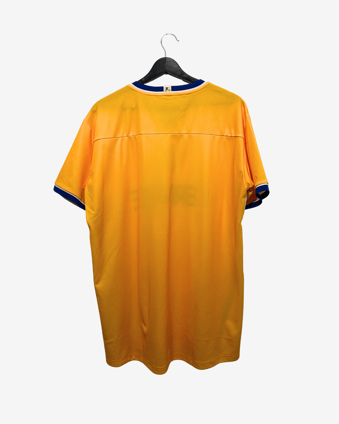 Yellow sports jersey on a hanger against a white background