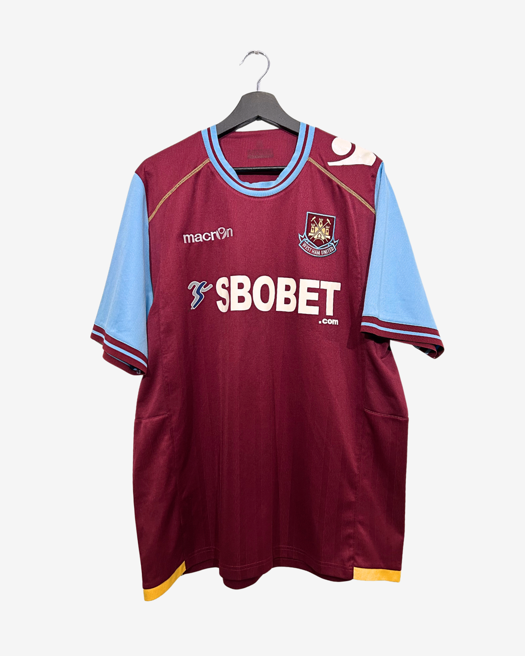 Maroon sports jersey with blue sleeves on a hanger against a white background