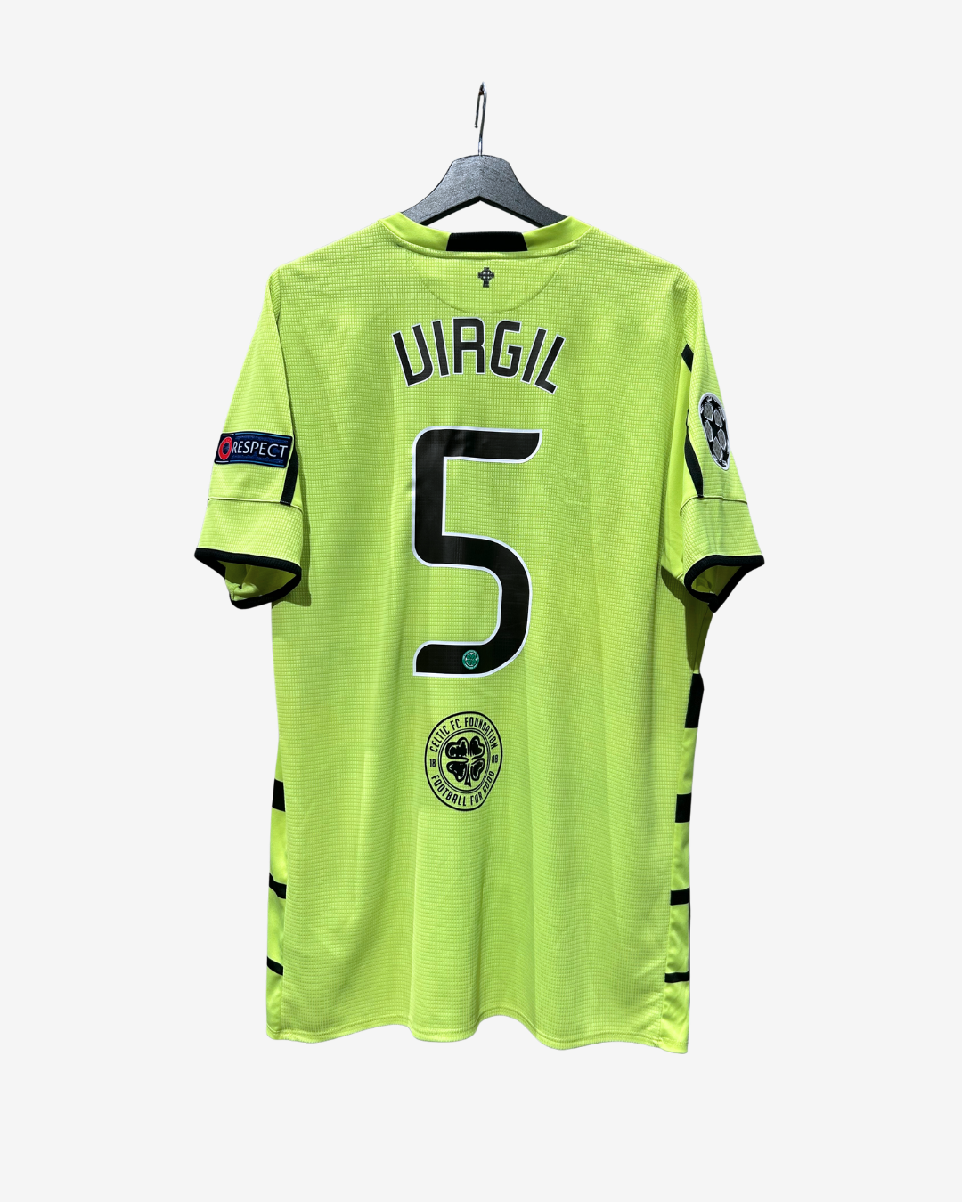 A bright neon yellow-green Sporting Lisbon soccer jersey hanging on a black hanger against a light gray background. The back of the jersey features the name 'UIAGIL' and the number '5' in black, with the club crest below.