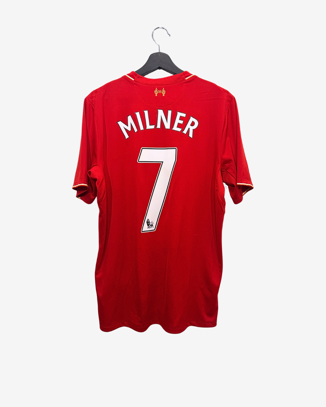 Red sports jersey with 'Milner' and number '7' on a hanger against a white background