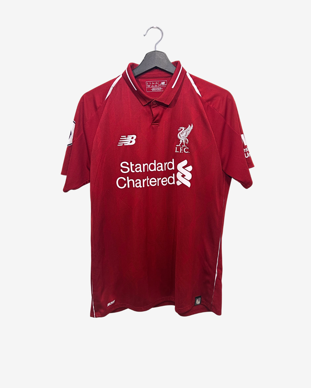 Red sports jersey with branding on a hanger against a white background