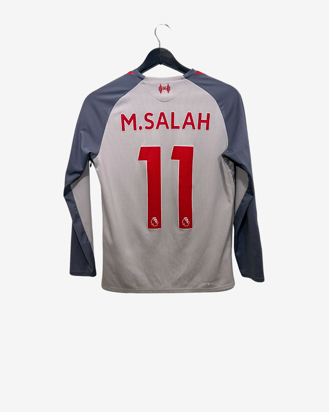 Gray sports jersey with red text and numbers on a hanger against a white background