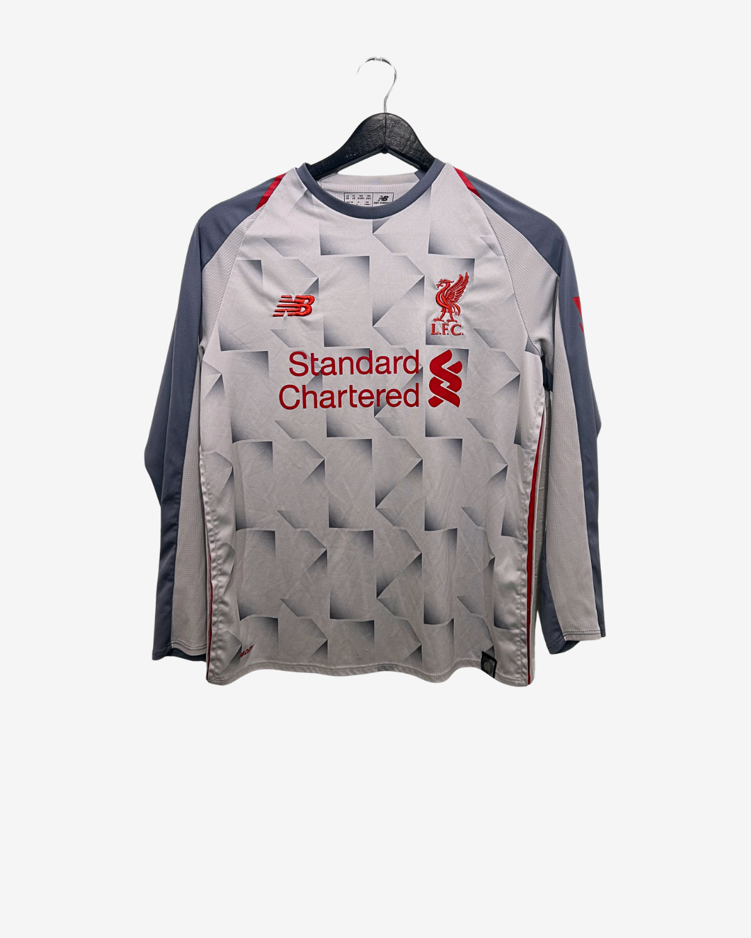 Gray sports jacket with branding on a hanger against a white background