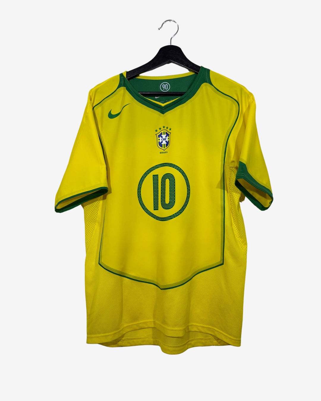 A yellow and green Nike Brazil national football team jersey with the number 10 on the front, hanging on a black hanger against a light gray background.