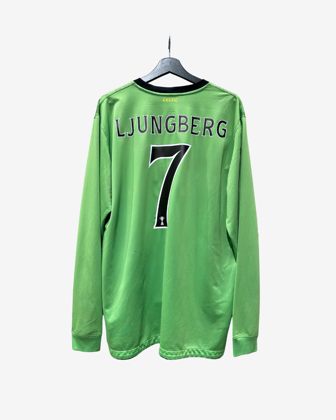 A bright green long-sleeve soccer jersey hanging on a black hanger against a light gray background. The back of the jersey features the name 'LJUNGBERG' and the number '7' in black.