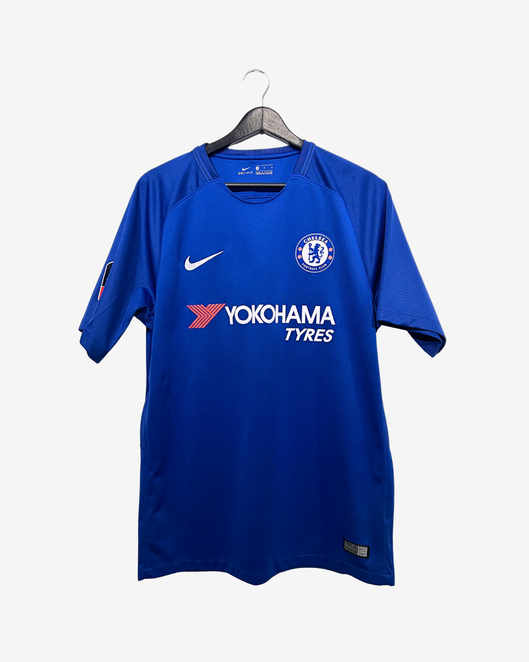 Blue sports jersey with visible branding on a hanger against a white background