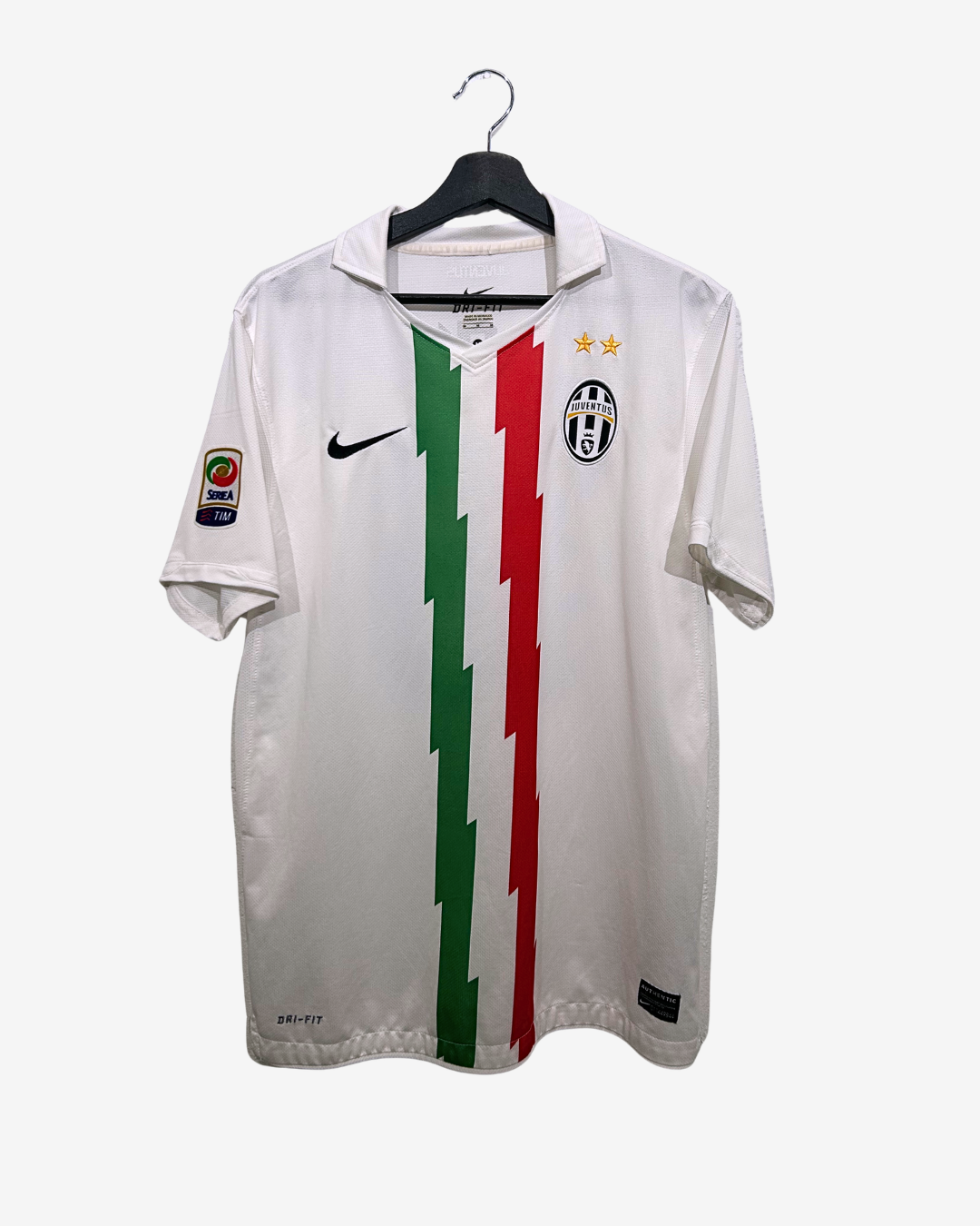 White sports jersey with red and green stripes on a hanger against a white background