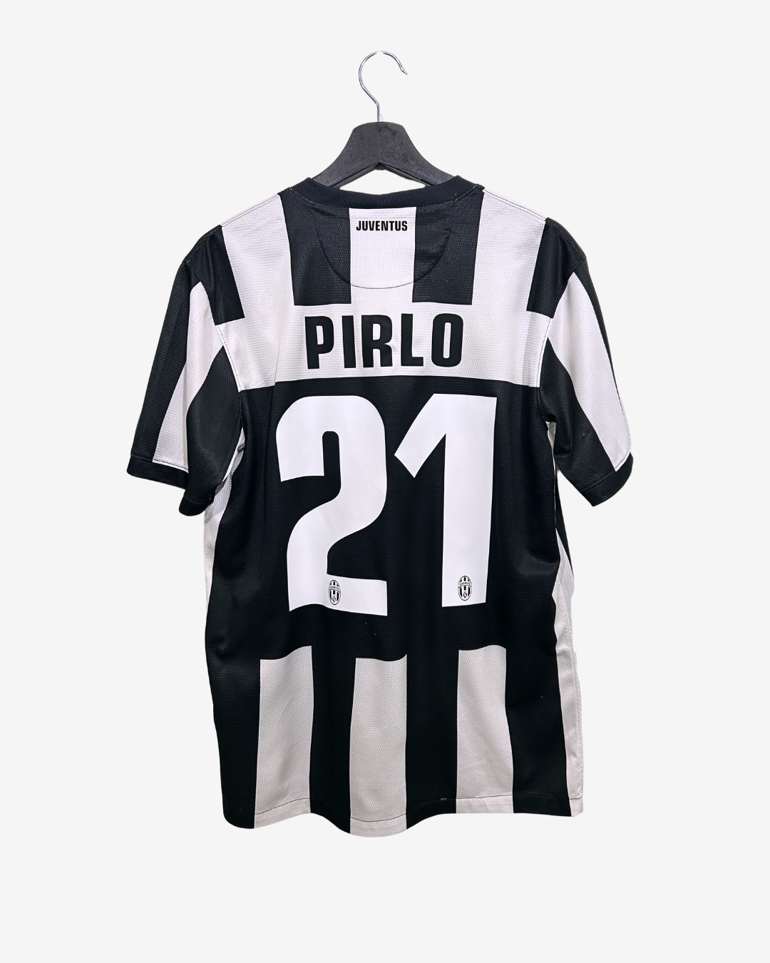 Black and white striped soccer jersey with 'Pirlo' and number '21' on a hanger against a white background.