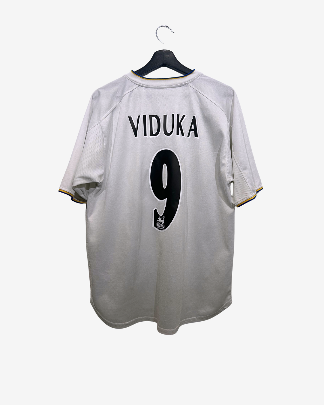 White sports jersey with 'VIDUKA' and number '9' on a hanger against a white background