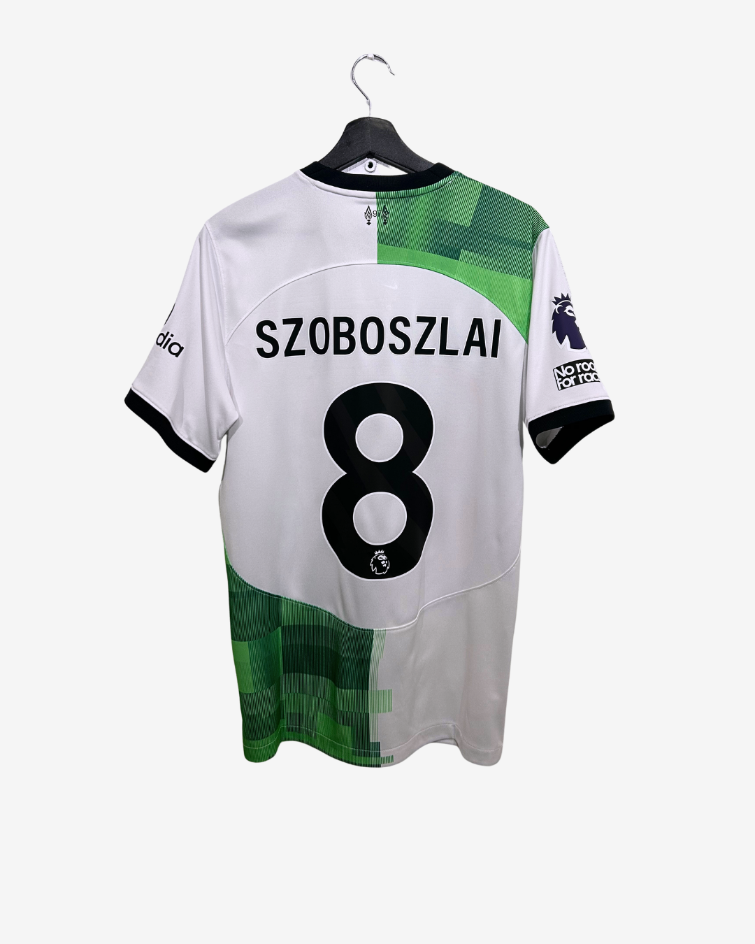 White sports jersey with green accents, featuring the name 'Szoboszlai' and number '8', on a hanger against a white background.