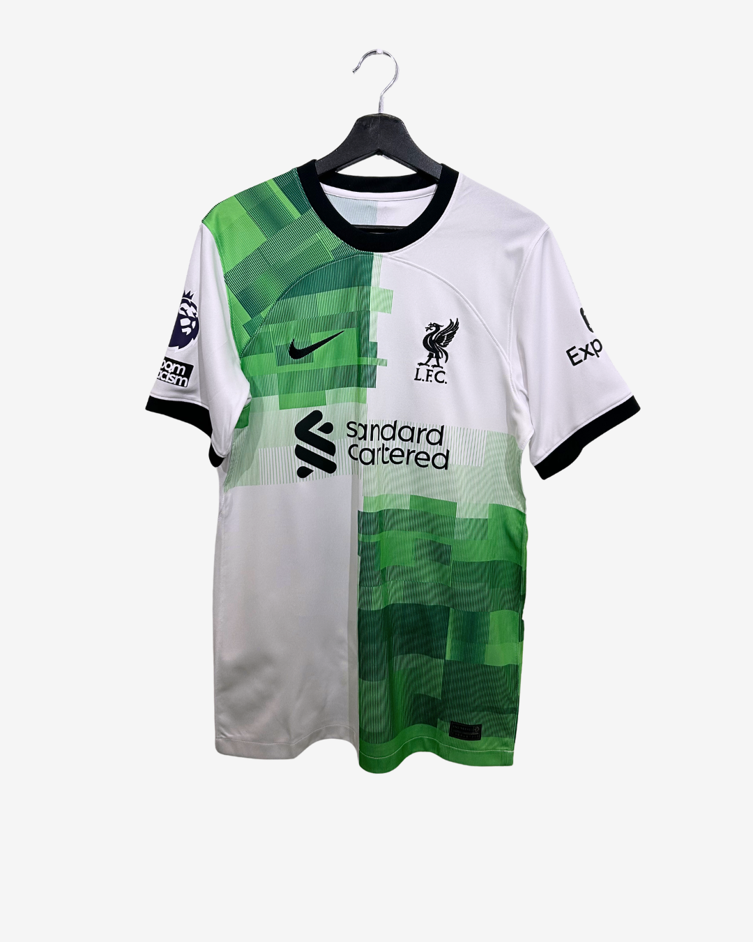 Green and white sports jersey with branding on a hanger against a white background