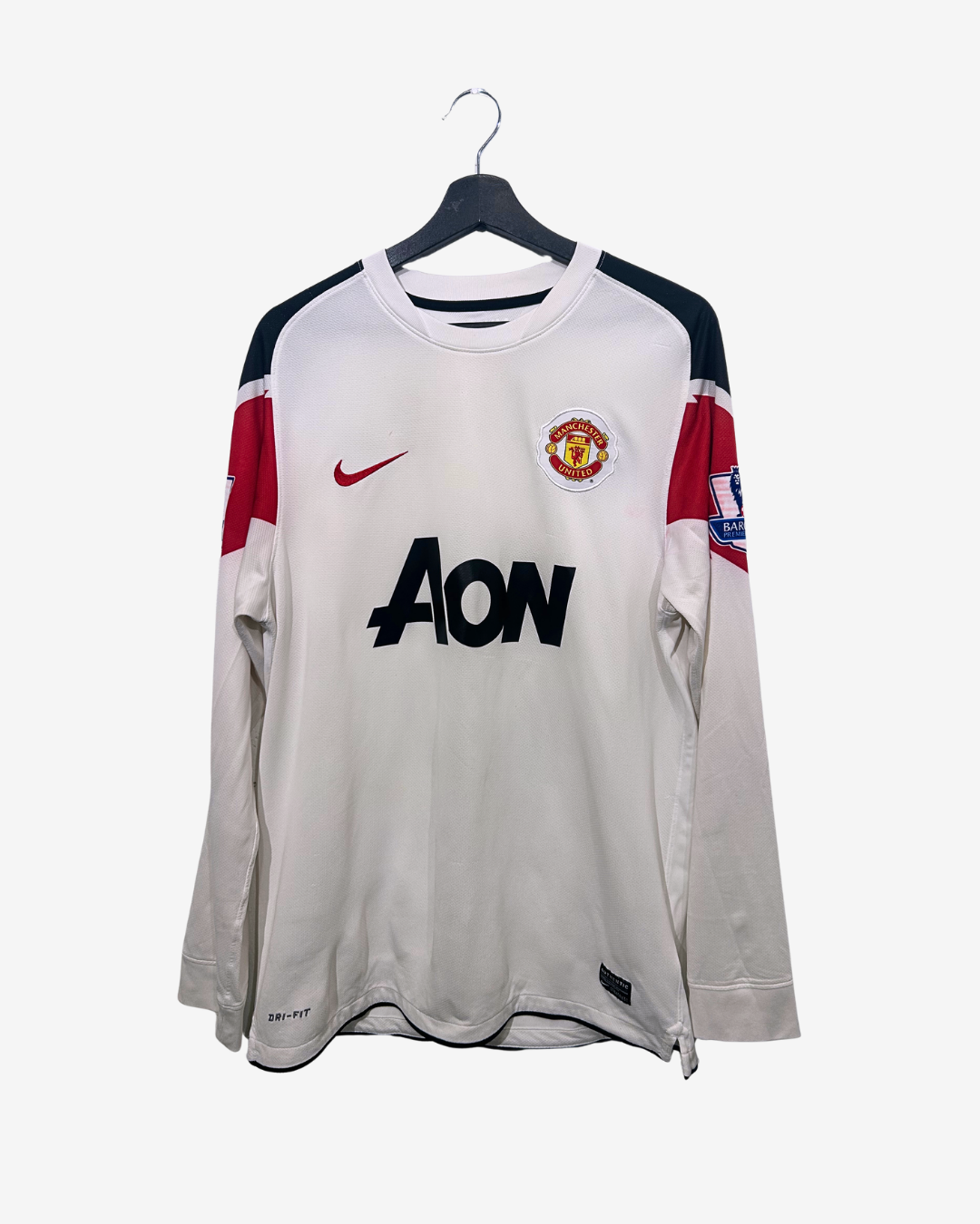 Man United jersey with Nike and Aon logos on a white background