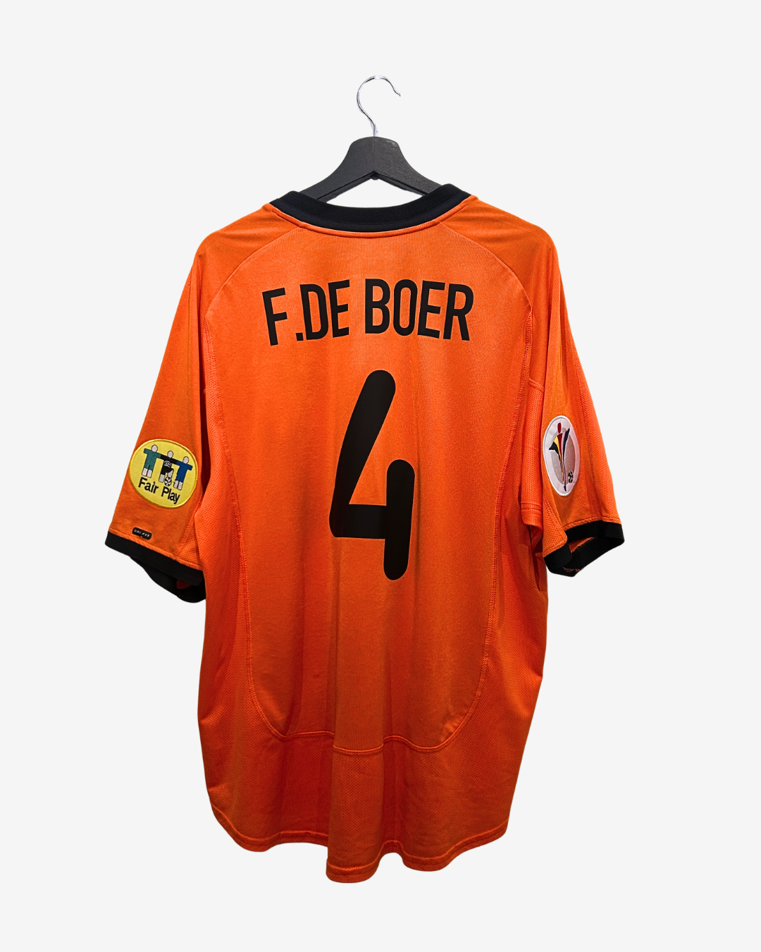 Orange sports jersey with 'F.De Boer 4' on a hanger against a white background
