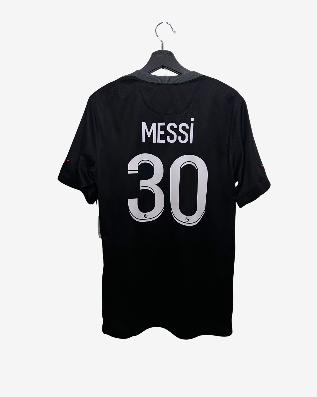 Black t-shirt with 'Messi 30' printed on a hanger against a white background