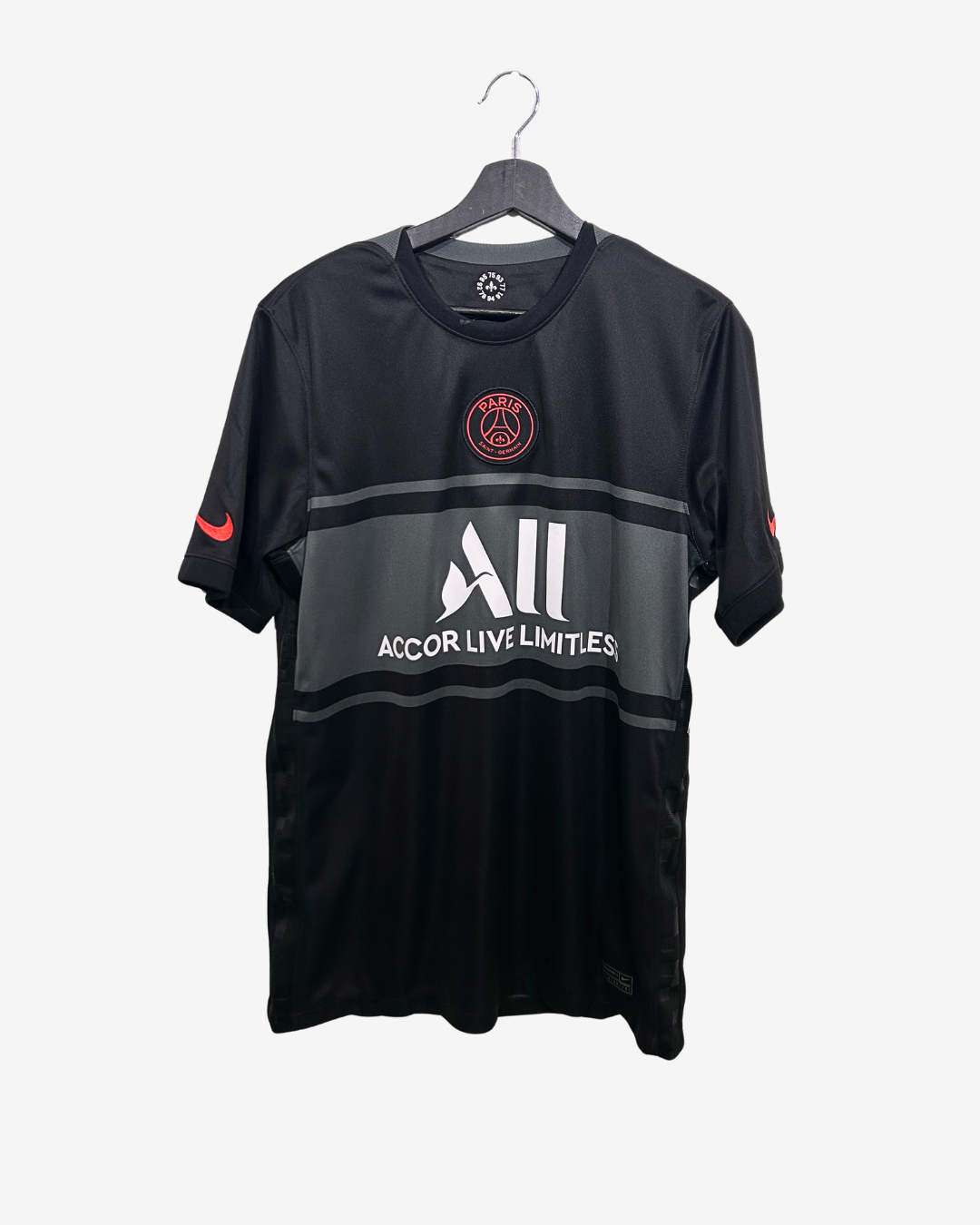 Black sports jersey with visible branding on a hanger against a white background