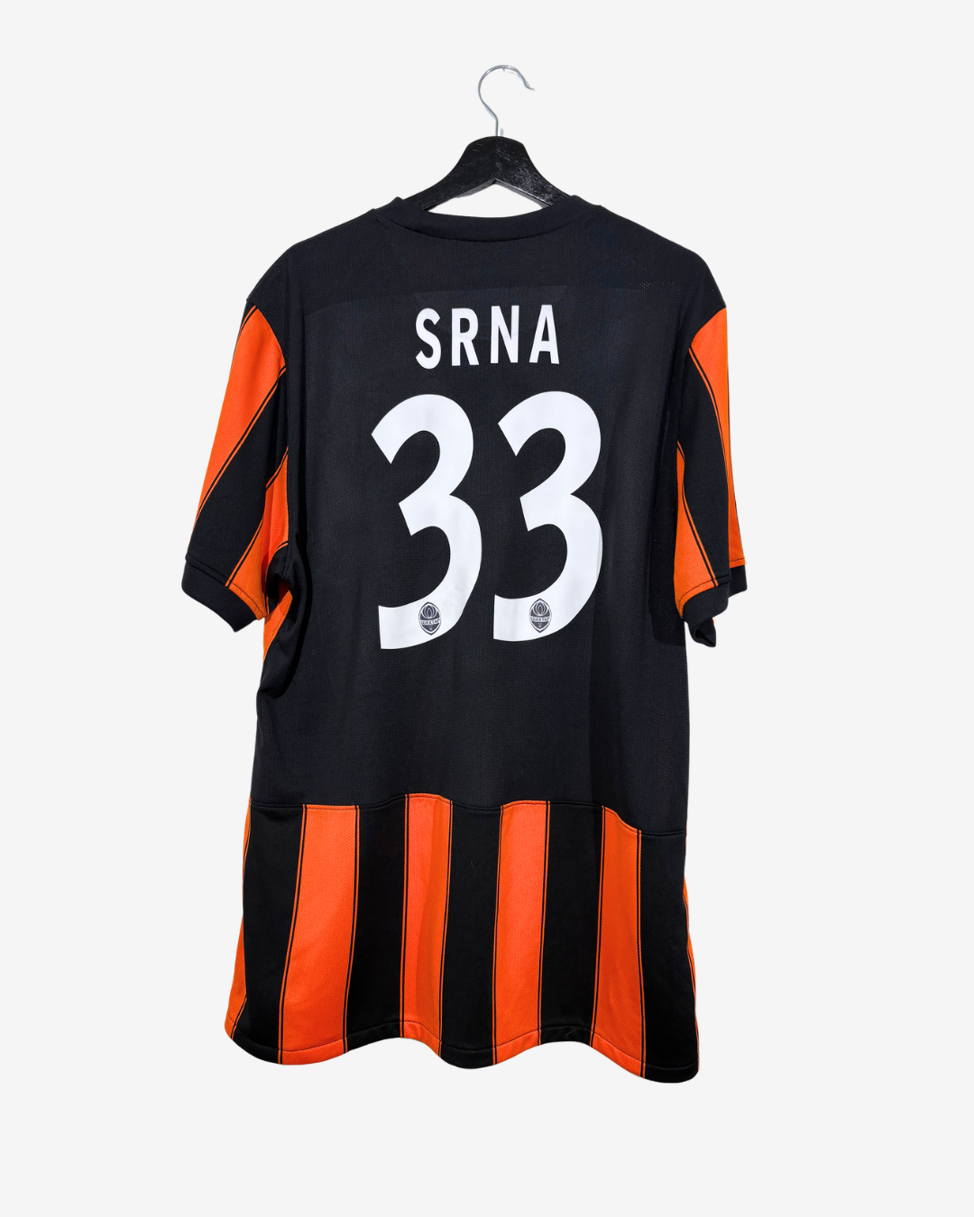 A black and orange striped football jersey with 'SRNA' and the number '33' printed on the back, hanging on a black hanger against a light gray background.