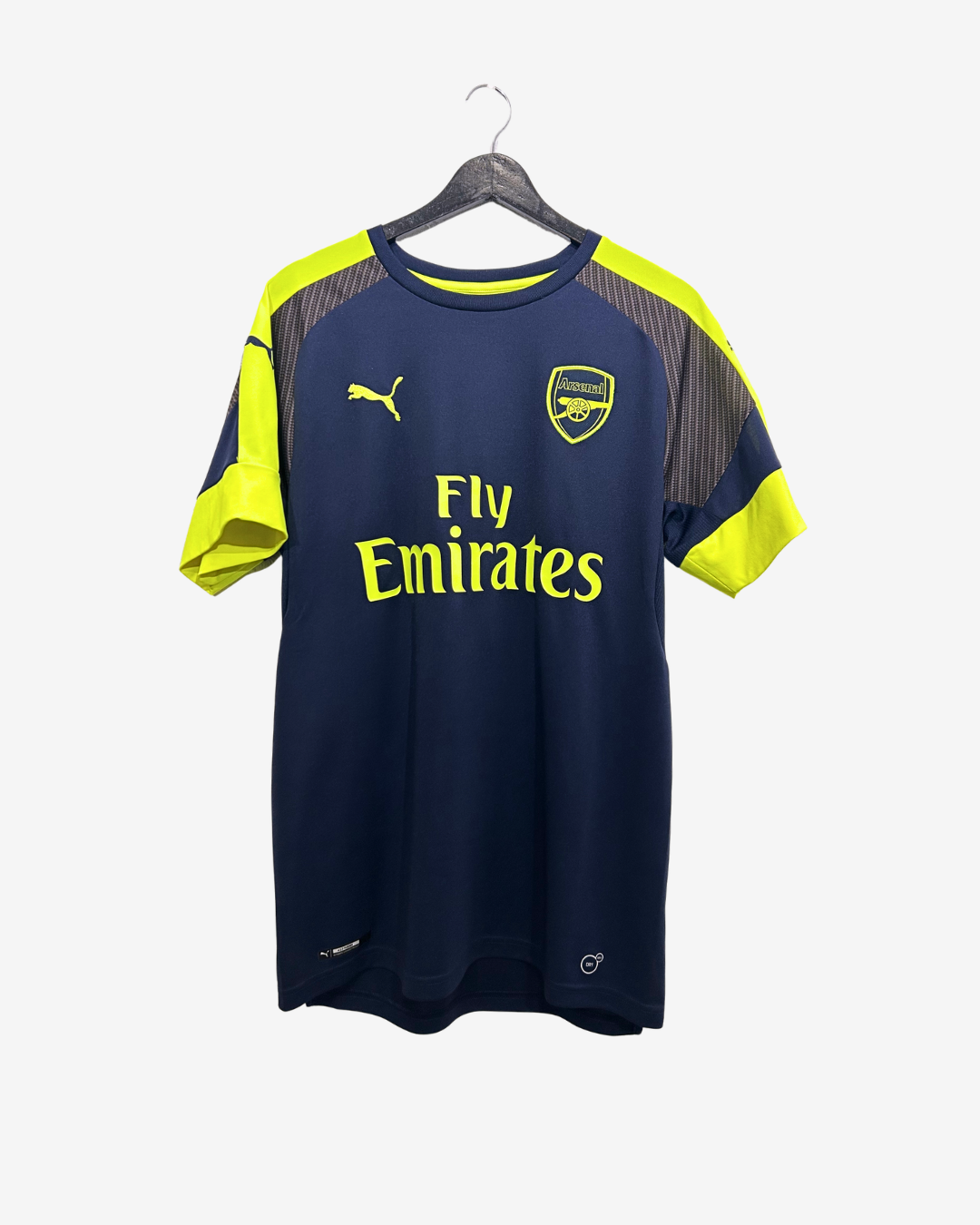 Navy and yellow sports jersey with Emirates logo on a hanger