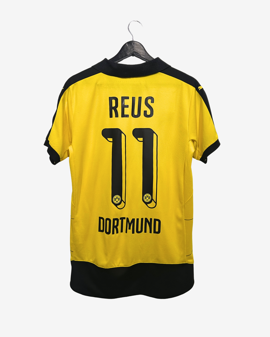 Yellow sports jersey with 'REUS' and number '11' on a hanger against a white background