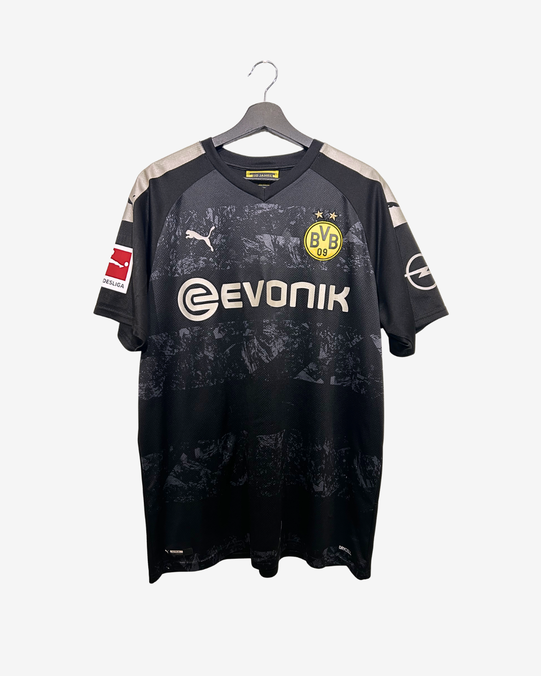 Black sports jersey with visible branding on a hanger against a white background