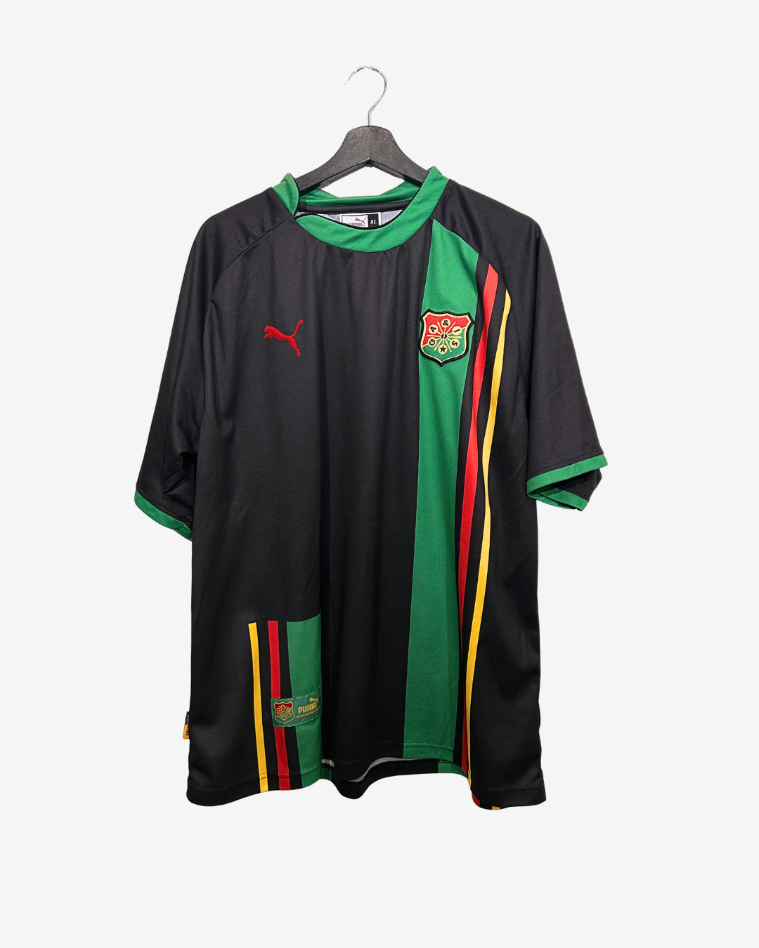 Black sports jersey with green and red accents on a hanger against a white background