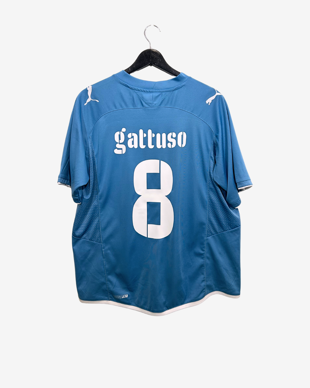 Blue sports jersey with 'gattuso' and number '8' on a hanger against a white background