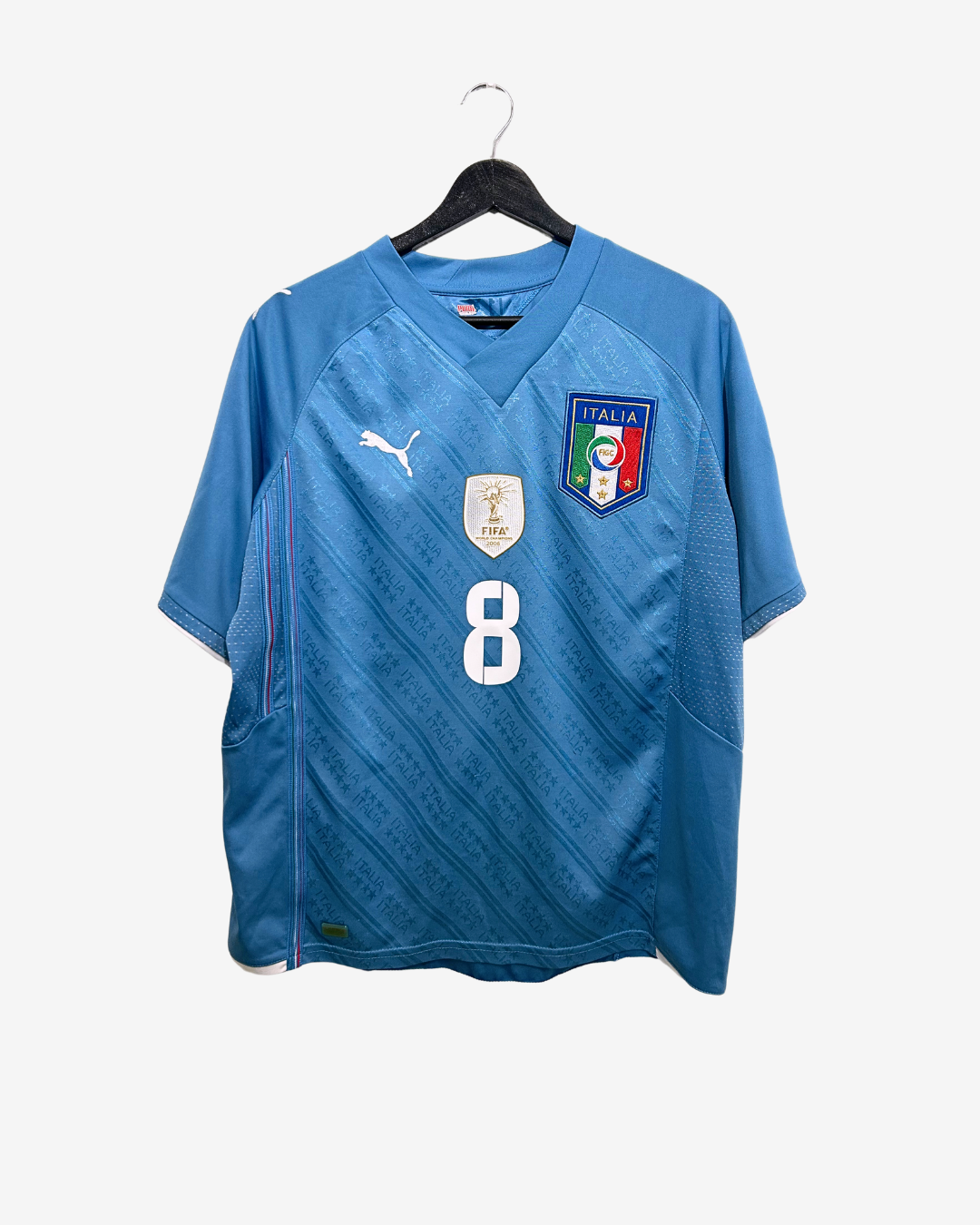 Blue sports jersey with number 8 and Italian flag on a hanger against a white background