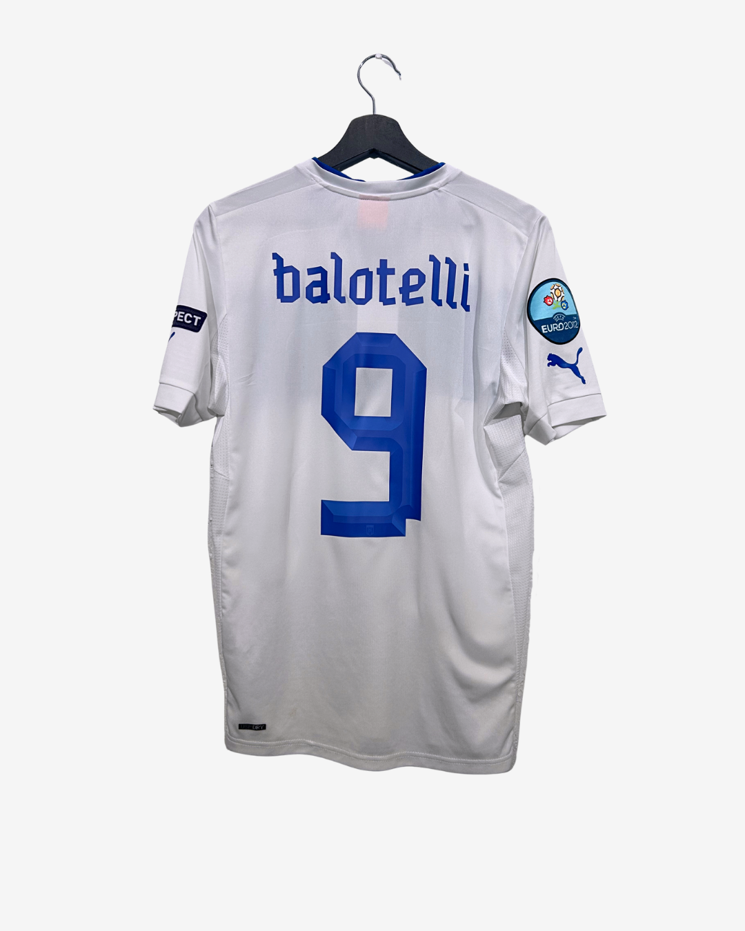 White soccer jersey with blue number 9 and 'balotelli' text, hanging on a white background.