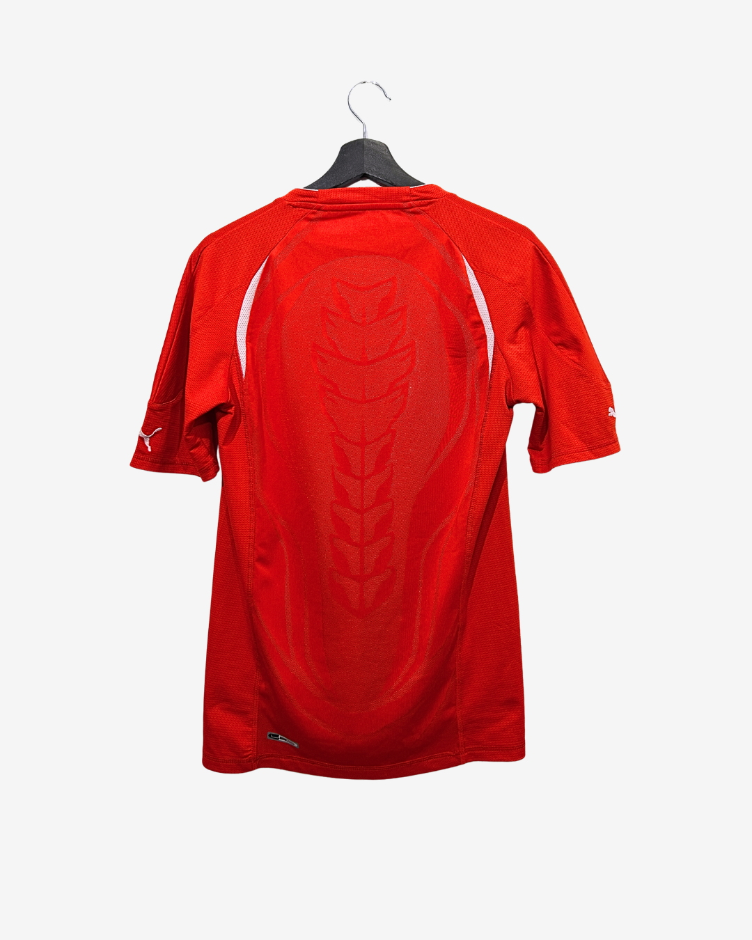 Red sports jersey on a hanger against a white background