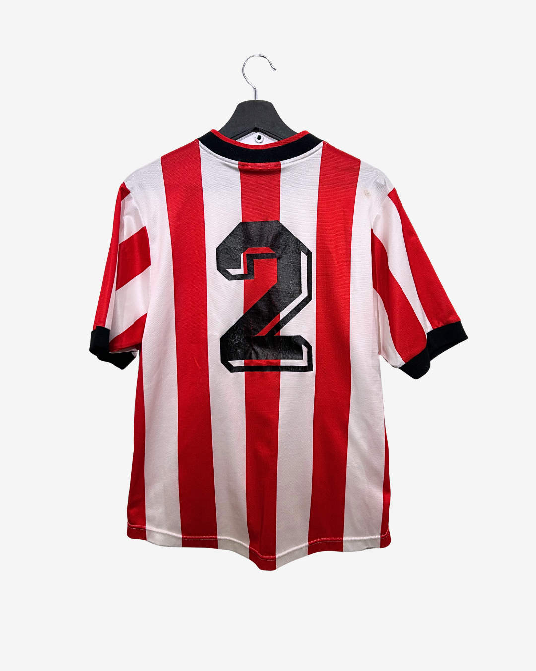 Red and white striped jersey with number 2 on a hanger against a white background