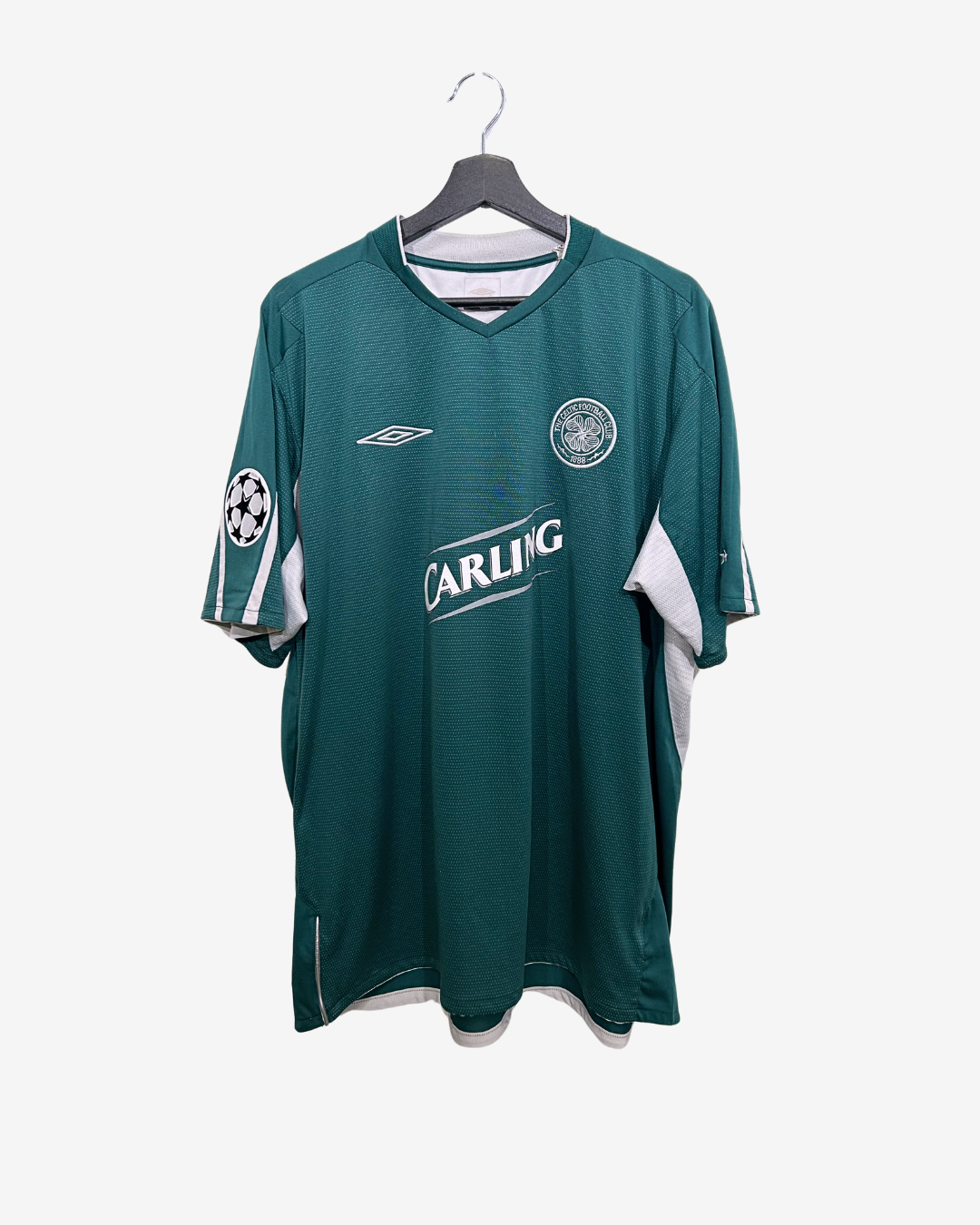 Green sports jersey with visible branding on a white background