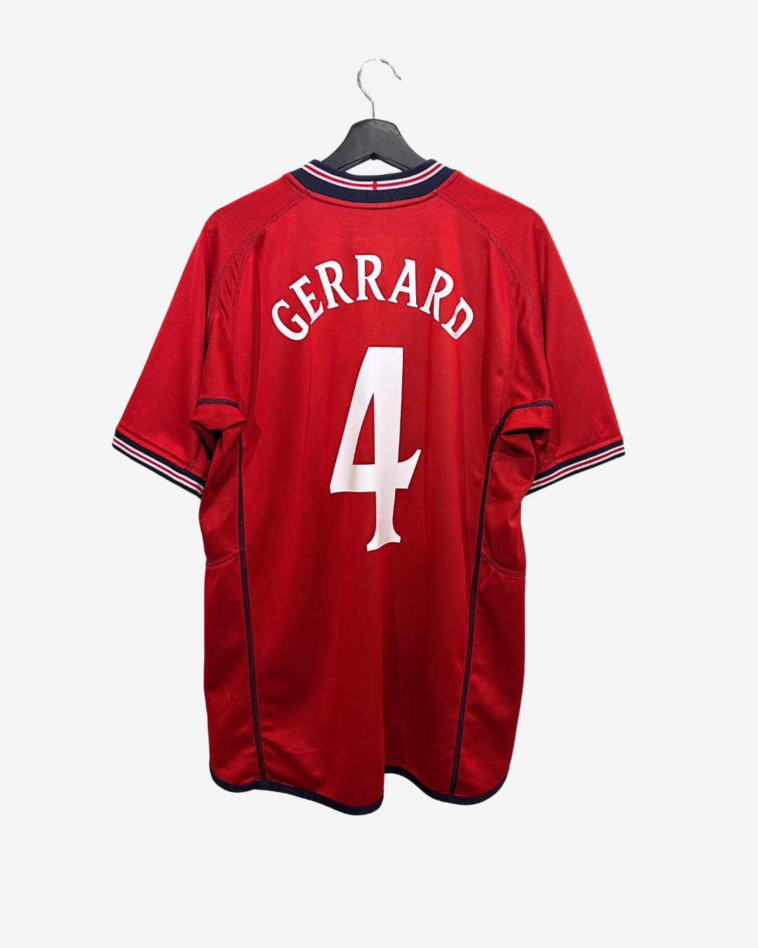 Red sports jersey with 'Gerrard' and number '4' on a hanger against a white background