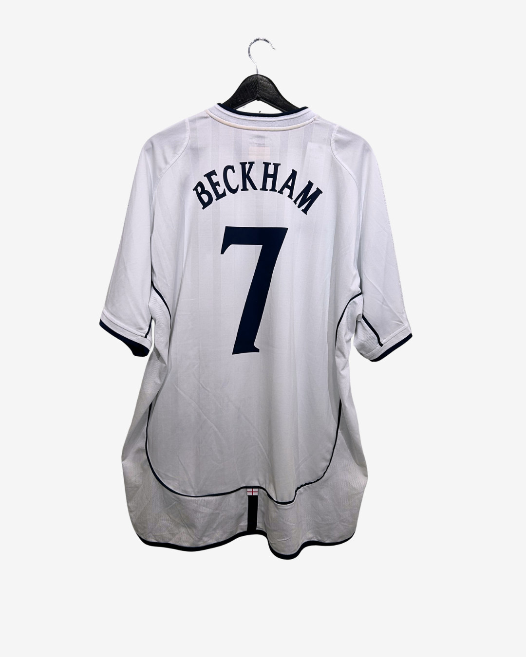 White sports jersey with 'Beckham' and number '7' on a hanger against a white background