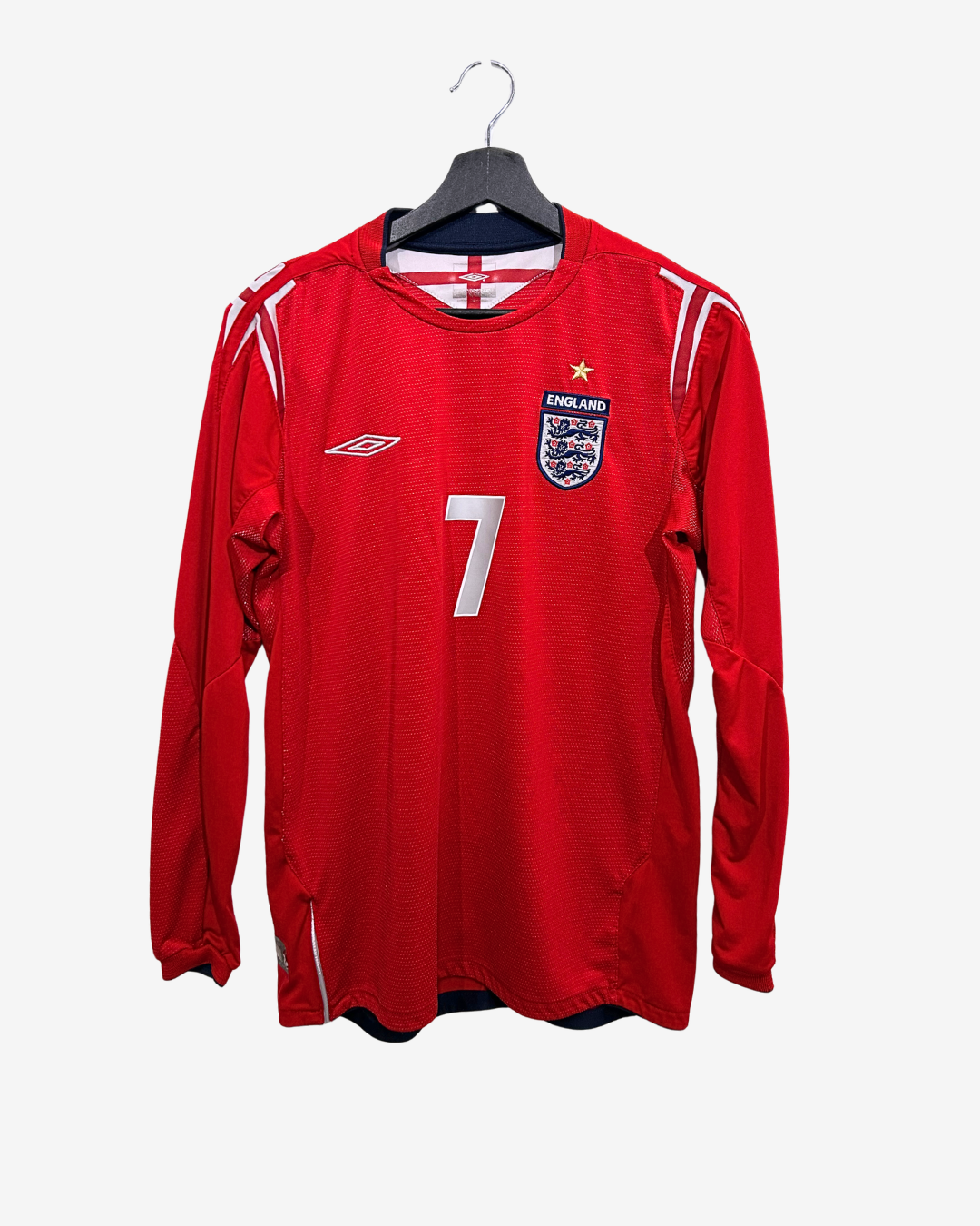 Red soccer jersey with number 7 on a hanger against a white background