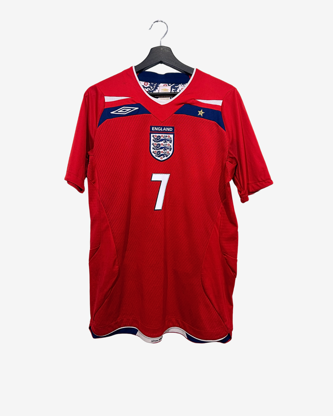 Red England soccer jersey with number 7 on a hanger against a white background