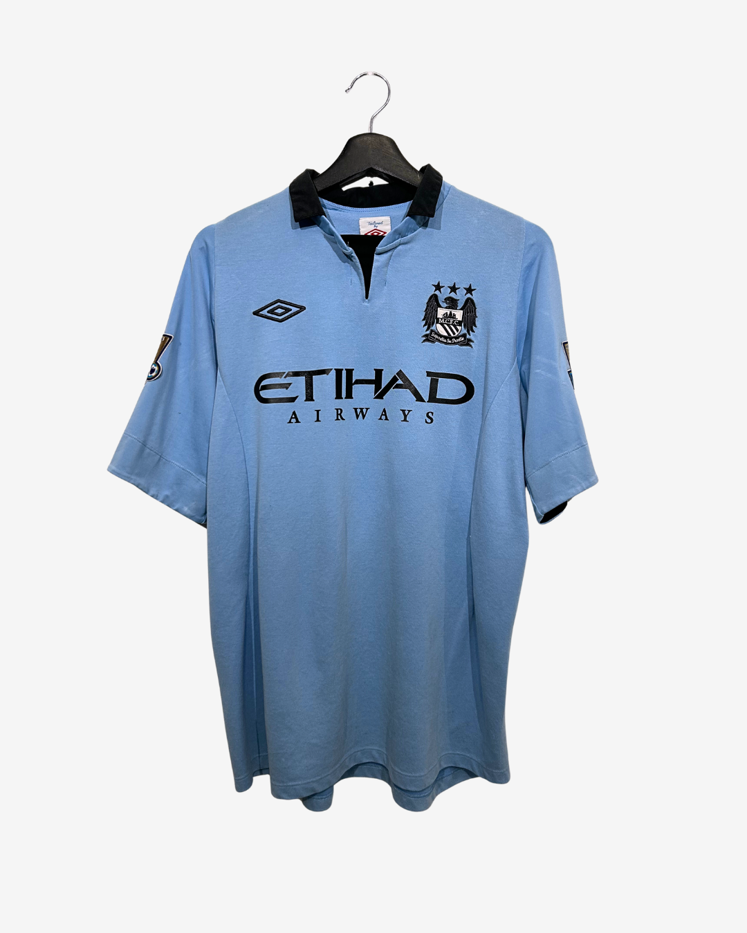 Blue sports jersey with branding on a hanger against a white background