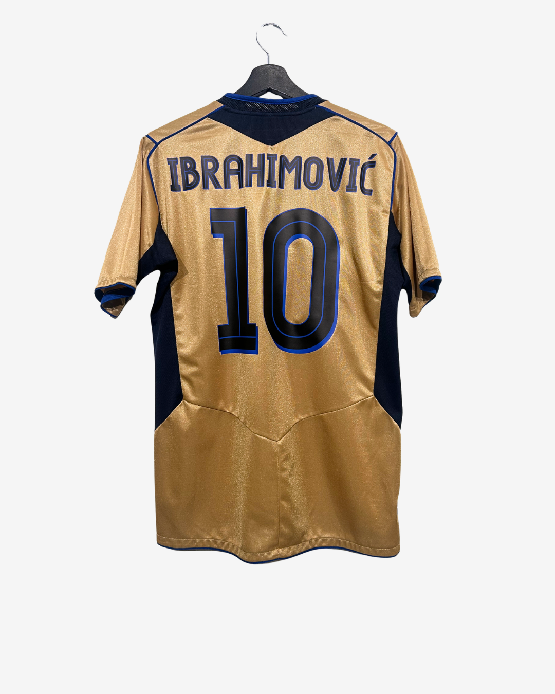 Gold sports jersey with 'Ibrahimovic' and number '10' on a hanger against a white background