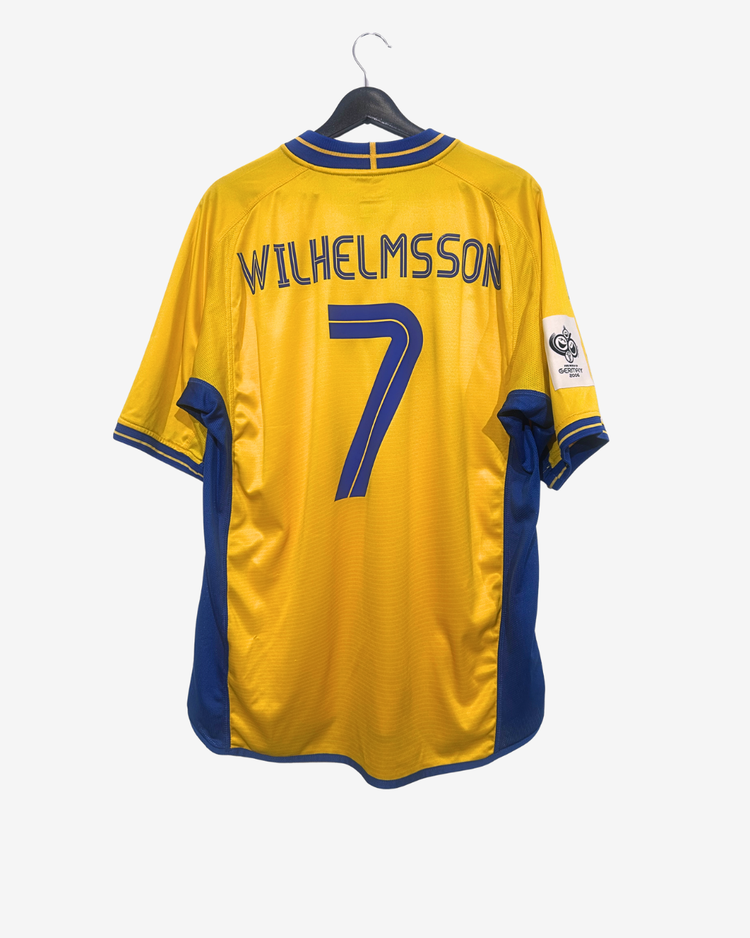 Yellow sports jersey with blue accents, number 7, and name 'Wilhelmsson' on a white background.