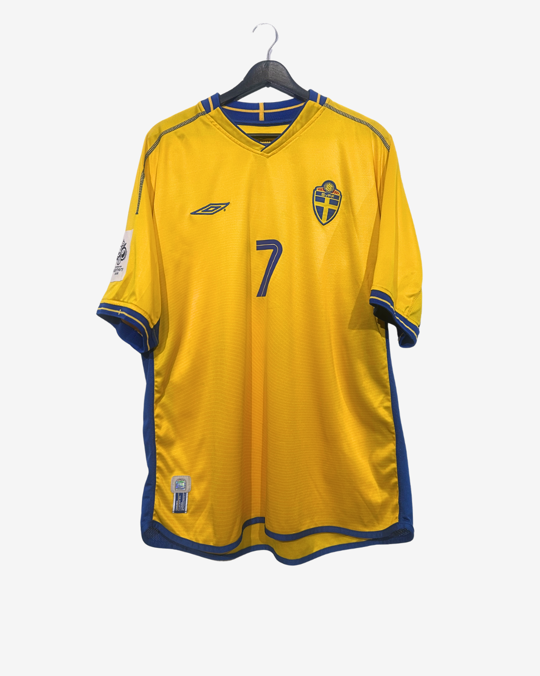 Yellow sports jersey with blue accents on a hanger against a white background