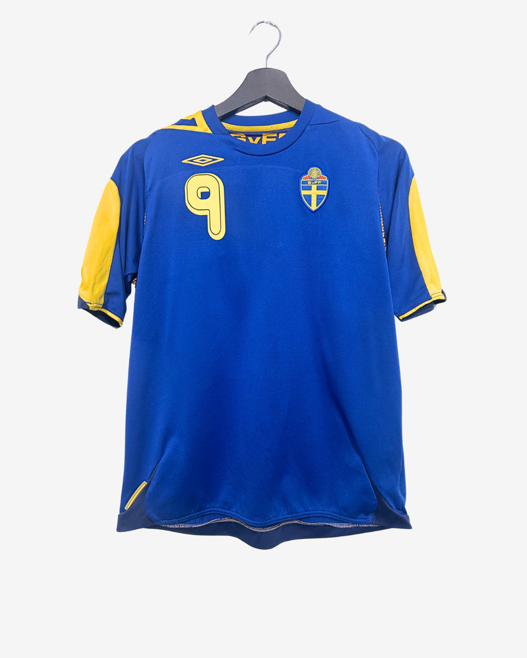 Blue sports jersey with yellow accents on a hanger against a white background