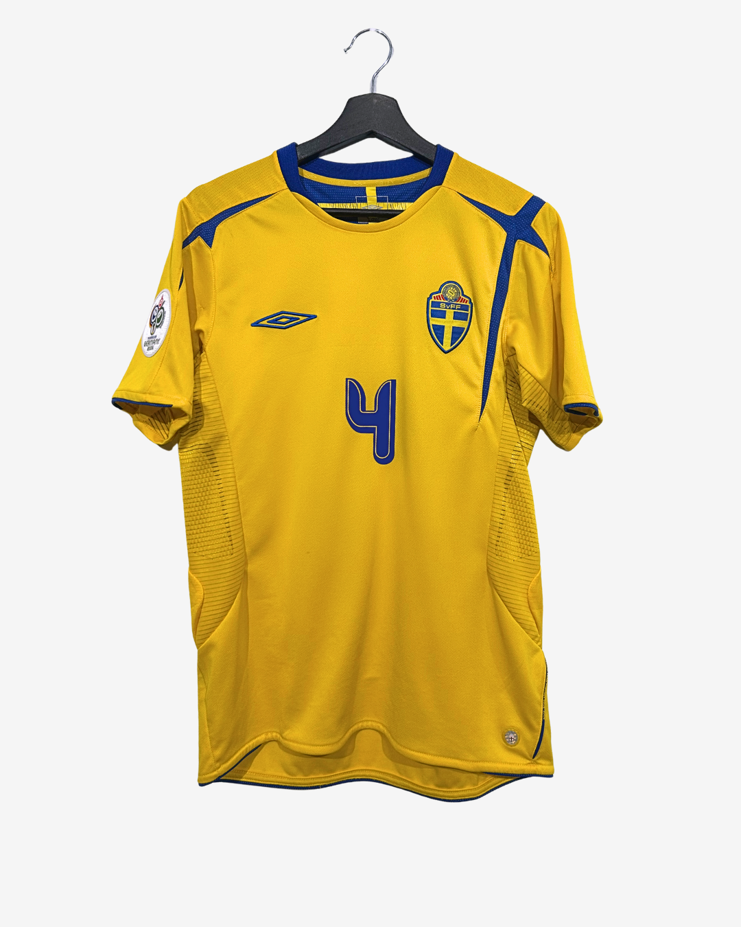 Yellow sports jersey with blue accents on a hanger against a white background