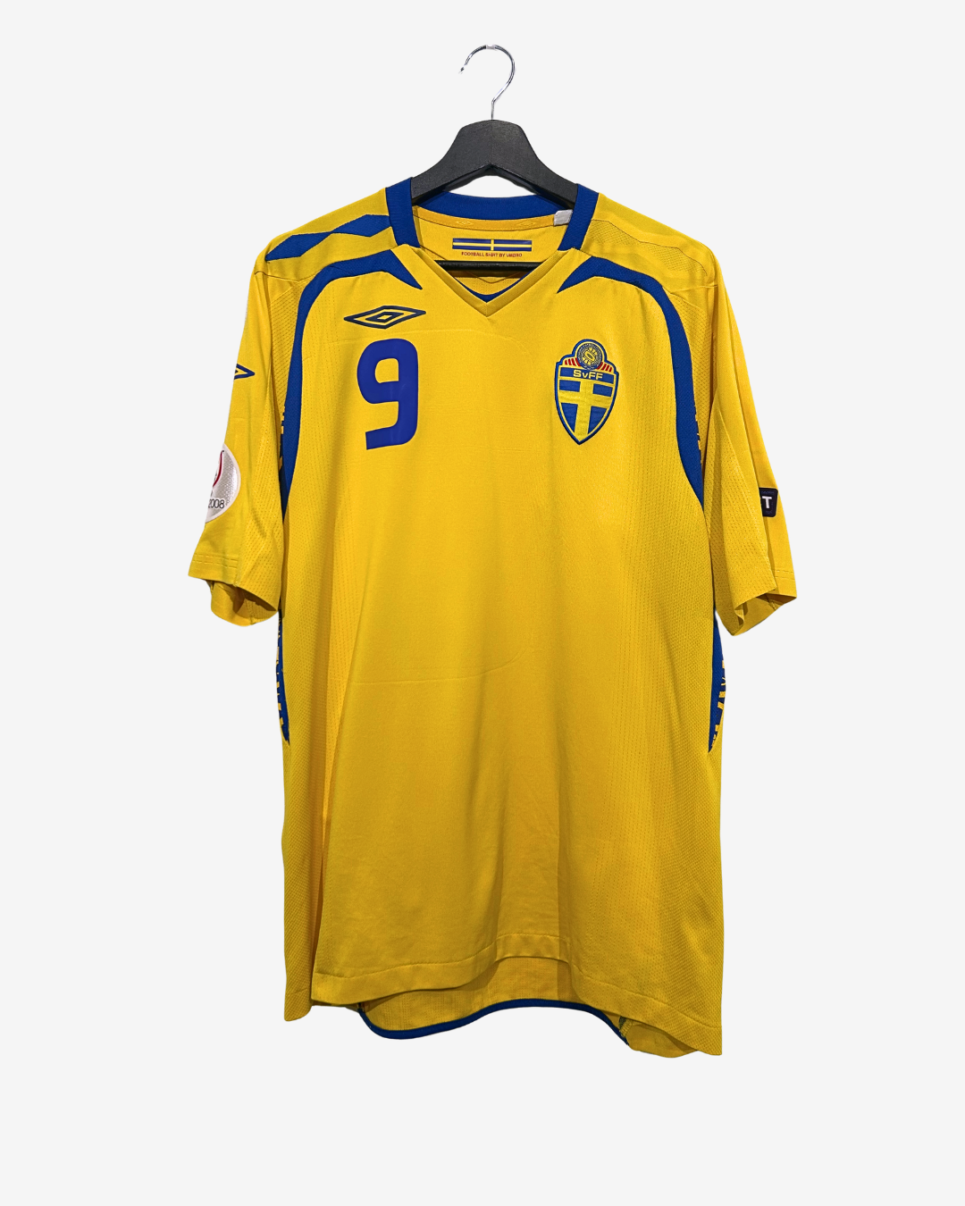 Yellow sports jersey with blue accents on a hanger against a white background