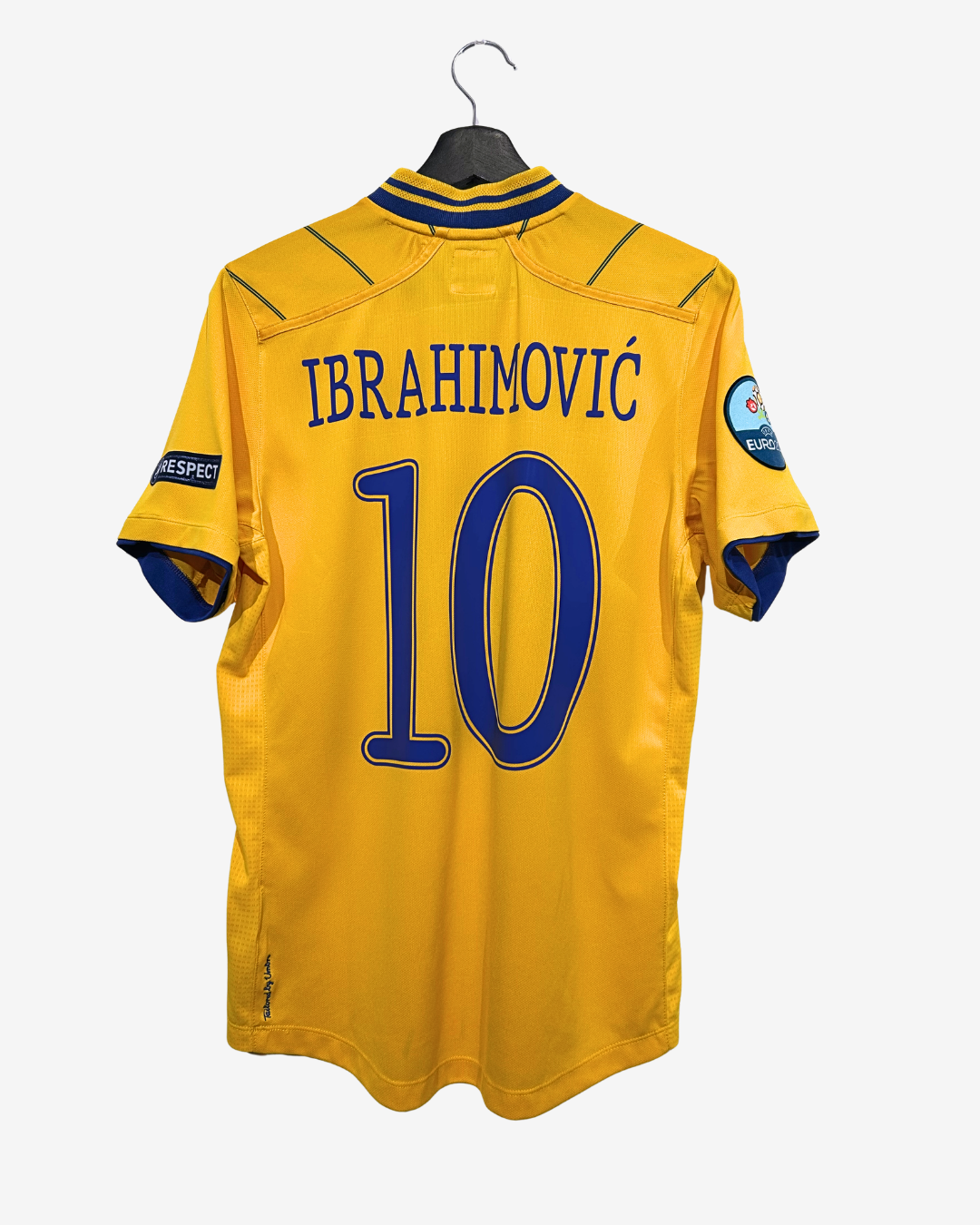 Yellow sports jersey with 'Ibrahimovic' and number '10' on a hanger against a white background