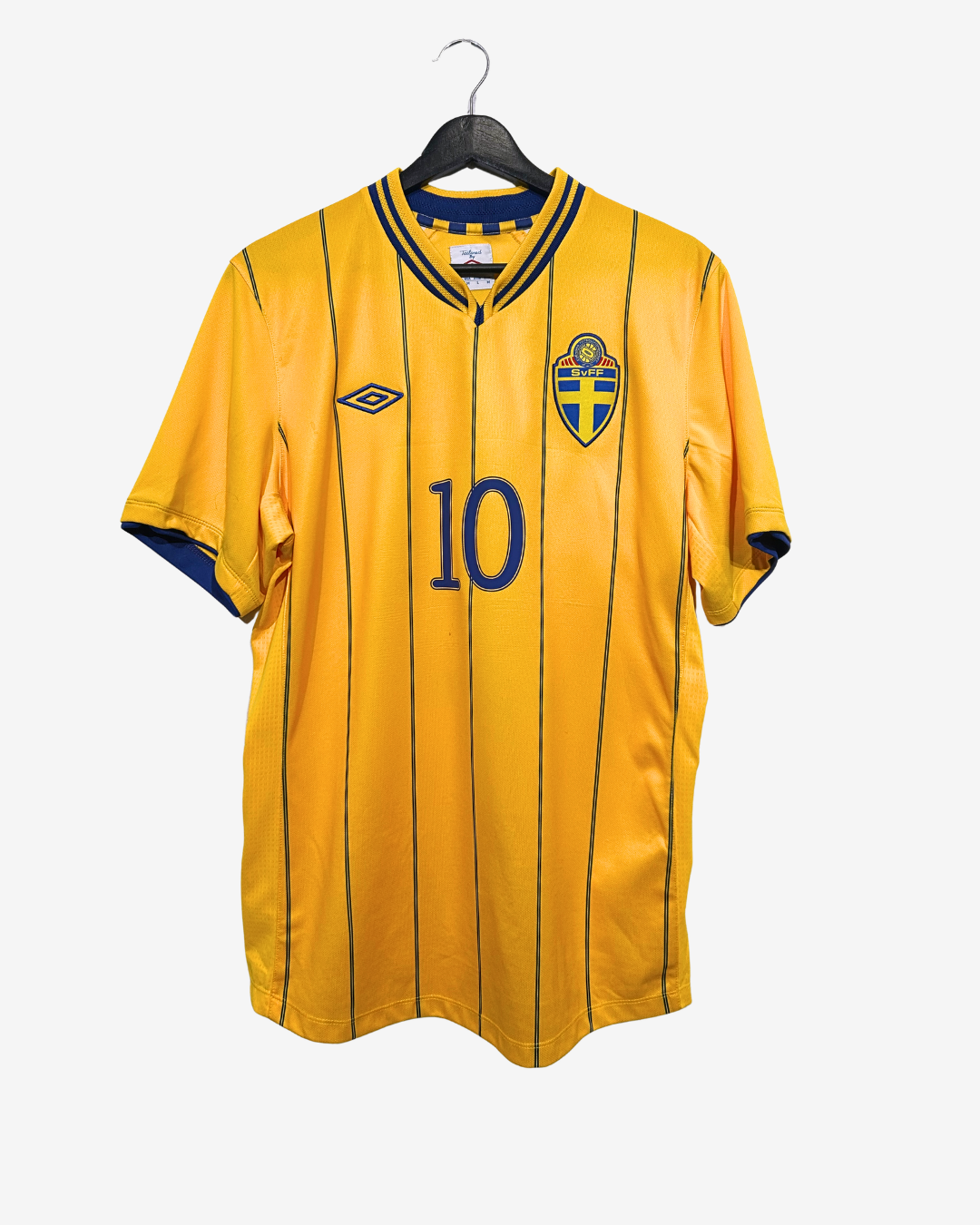 Yellow sports jersey with number 10 and emblem on a hanger against a white background