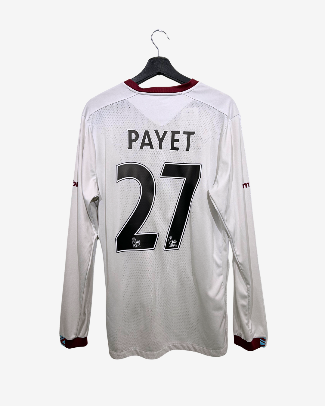 White sports jersey with 'PAYET' and number '27' on a hanger against a white background