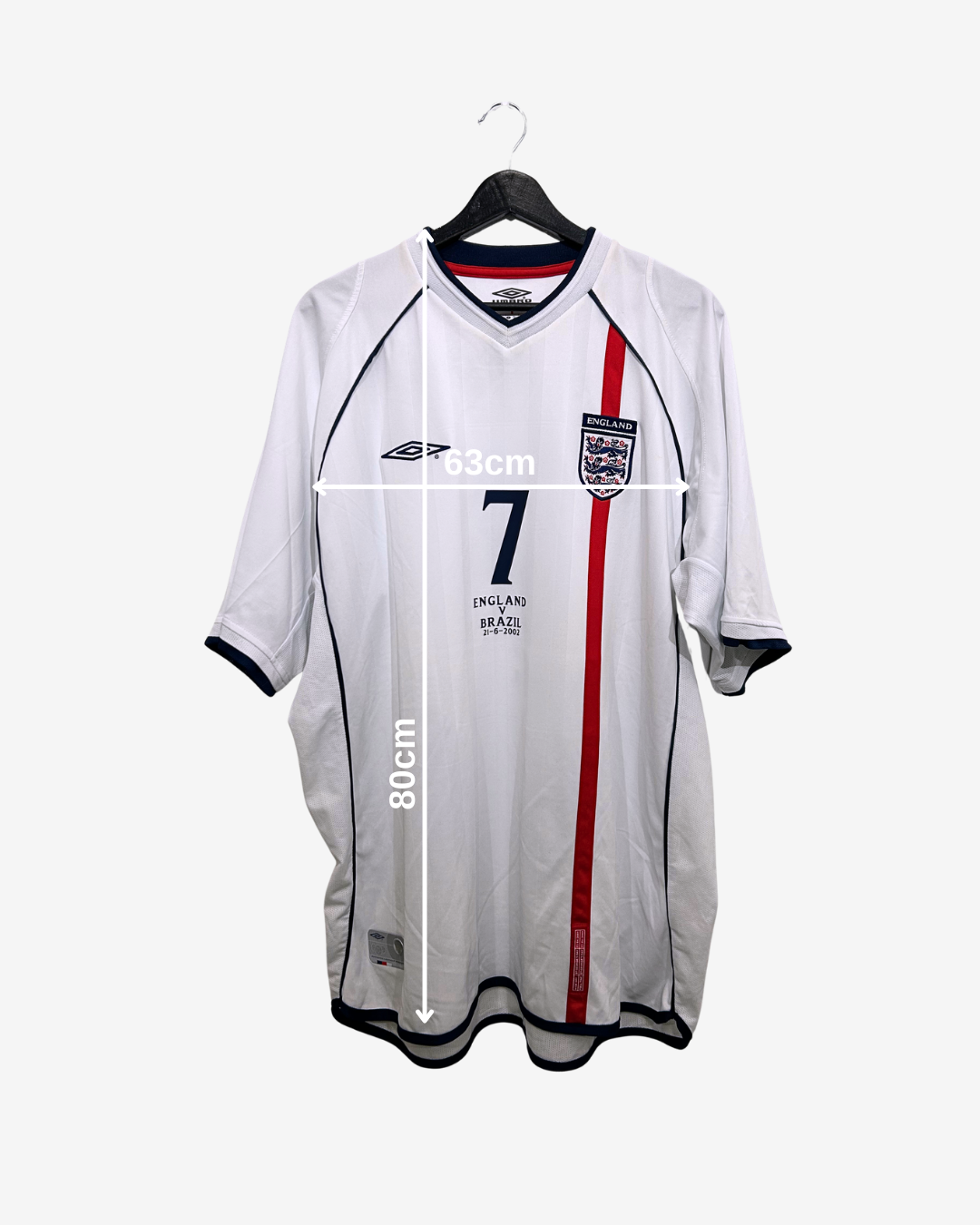 White sports jersey with red stripe on a hanger, showing measurements.