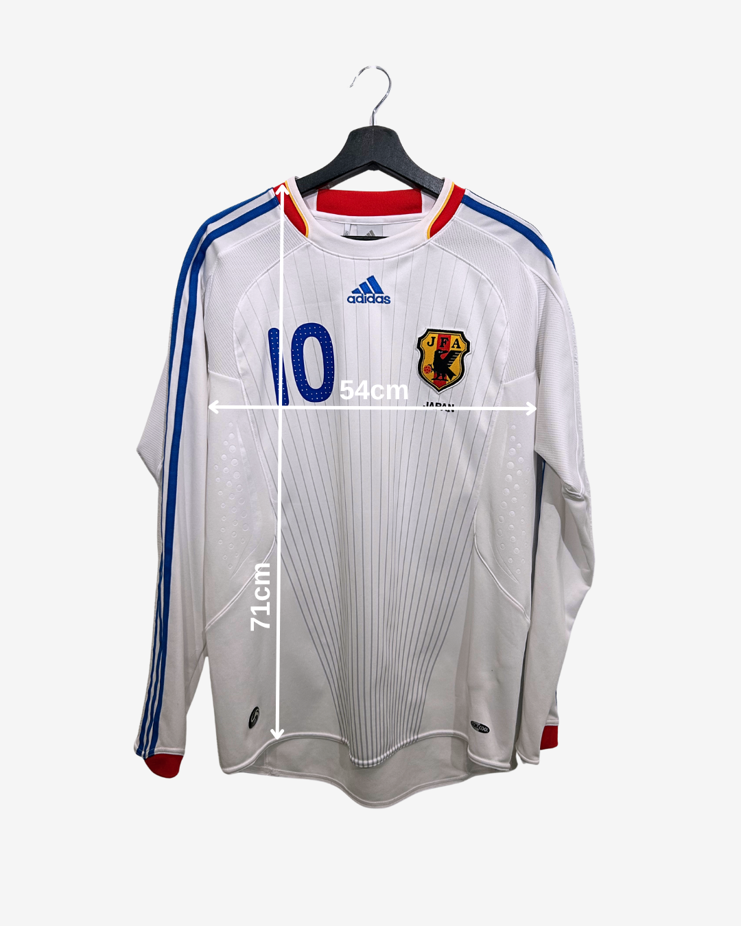 White sports jersey with Adidas logo on a hanger, featuring measurements.